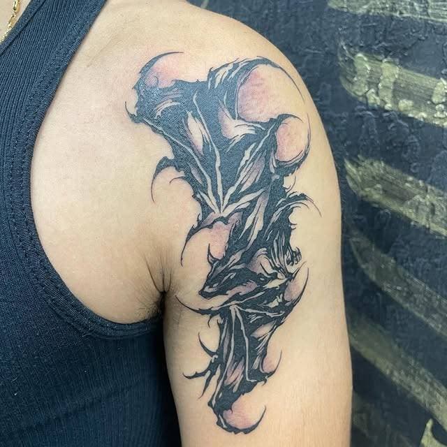 Abstract blackwork tattoo on upper arm